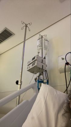 a hospital room with an iv and medical equipment on the wall next to it's bed