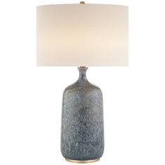 a blue vase lamp with a white shade on it