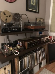 an old fashioned stereo system is on top of a shelf in a room with other items