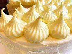 a close up of a cake with white frosting