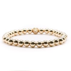 Introducing our 6mm Gold Ball, a must-have accessory for anyone looking to elevate their style. This stunning piece is perfect for gifting or treating yourself, with its warm and luxurious glow from the gold balls. It can be worn on its own or added to a stack of bracelets for a standout look. Whether it's a special occasion or just because, it's sure to impress and become a beloved staple in any collection. Luxury Gold Beaded Bracelets With Round Beads, Classic Gold Stretch Bracelet For Gifts, Classic Gold Stretch Bracelet As Gift, Classic Gold Stretch Bracelet Gift, Gold Beaded Bracelets With Round Beads For Meditation, Classic Gold Beads Stretch Bracelet Gift, Classic Gold Beads Stretch Bracelet As Gift, Classic Gold Stretch Bracelet With 8mm Beads, Classic Gold Beads Stretch Bracelet For Gift