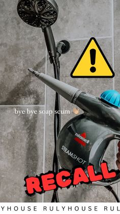 a hand holding a blow dryer in front of a tile floor with the words recall written on it