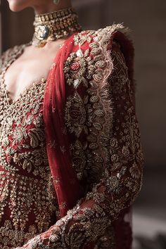 Pakistani Bridal Red Lehenga and Embellished Gown Dress is a stunning attire as it has all the qualities of a flawless Bridal dress. This stunning Pakistani Bridal Outfit is hand-embellished with mukaish, gold ornaments, and shimmering details, making this masterpiece an epitome of royalty and grace. Pakistani Bridal Gown: The beautiful Pakistani Bridal Gown in a stunning red shade comes in graceful open style and is intricately emblazoned with zardosi, resham, dabka, marori, and embroidery. Thi Red Wedding Dress Pakistani, Pakistani Bridal Red, Bridal Dress Red, Red Pakistani Bridal Dress, Bridal Red Lehenga, Pakistani Gown, Pakistani Bridal Couture, Casual Bridal Dress, Burgundy Gown