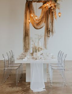 a white table topped with lots of chairs