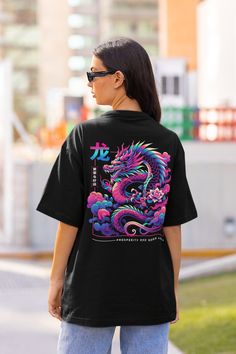 Embrace the power, luck, and charisma of the dragon with our 'Year of the Dragon Sweatshirt.' This stunning sweater pays homage to the Chinese zodiac's Year of the Dragon, symbolizing strength, wisdom, and good fortune. Get yours now! Available on tshirts, sweatshirt and hoodies: https://www.etsy.com/shop/TheNims?search_query=Year+Of+The+Dragon Browse through my other awesome items here: http://thenims.etsy.com/ UNISEX TEES Gildan 5000™ (CUSTOMER FAVORITE) * 100% Cotton (fiber content may vary f Black Crew Neck T-shirt With Dragon Print, Short Sleeve Tops With Dragon Print For Streetwear, Casual Dragon Design Tops For Streetwear, Dragon Print Crew Neck Top For Streetwear, Casual Tops With Dragon Design For Streetwear, Streetwear Dragon Print Short Sleeve T-shirt, Streetwear Short Sleeve T-shirt With Dragon Print, Dragon Sweatshirt, Chinese Streetwear