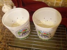 two buckets of ice cream sitting on a cooling rack