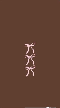 a pink bow on top of a brown background with the word love written below it