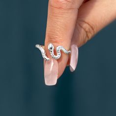 Crafted using sterling silver, our snake rings feature a winding shape & intricate engravings that mimic a snake's skin. A symbol of prowess. Elegant Silver Snake Ring, Adjustable Engraved Snake Ring, Silver Adjustable Engraved Snake Ring, Sterling Silver Snake-shaped Rings, Elegant Engraved Silver Snake Ring, Elegant Silver Engraved Snake Ring, Adjustable Silver Snake Ring Fine Jewelry, Elegant Sterling Silver Snake Ring, Unique Sterling Silver Snake Ring