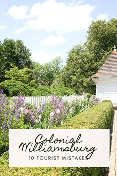 a white house surrounded by purple flowers and greenery with the words colonial melanisting on it