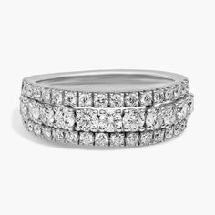 three rows of diamond rings stacked on top of each other, with the center surrounded by smaller round diamonds