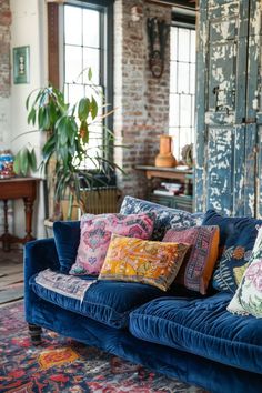 a blue couch with many pillows on it