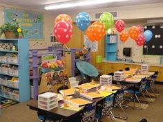 a classroom filled with lots of desks and balloons