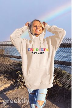 Soft, cute, and trendy, this Delta Delta Delta Sorority mad happy local optimist inspired hooded sweatshirt will quickly become your go-to cozy Tri Delta sweatshirt! The hoodie is a light tan/cream color. We print on high quality, soft, cozy materials, sustainably made and printed in the US. ♥ SIZING ♥ Unisex Sizing- For a more feminine, fitted look we recommend getting your size. For a more oversized look, we recommend sizing up. ♥ SHIP TIME ♥ Items may take up to 7 business days to process bef Theta Sweatshirt, Local Optimist, Mad Happy, Alpha Delta Pi Sorority, Alpha Alpha, Chi Omega Sorority, Sigma Delta Tau, Theta Phi Alpha, Sorority Sweatshirts