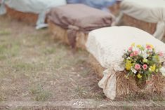 a bunch of hay bales with flowers on them