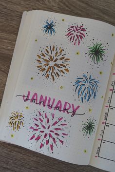 an open planner with fireworks and the word january written on it in pink, blue, yellow and green ink