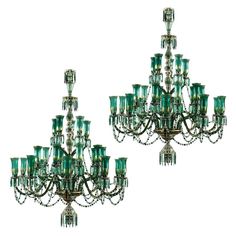 two green glass chandeliers are hanging from the ceiling