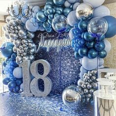 balloons and streamers decorate the backdrop for an 18th birthday party