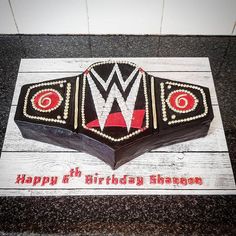 a birthday cake that is shaped like a wrestling ring