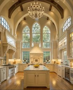 a large kitchen with an arched ceiling and wooden floors