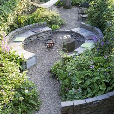 an outdoor seating area surrounded by plants and flowers