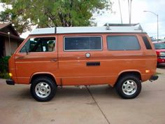 an orange van parked in front of a house