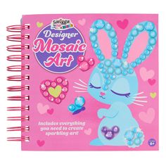 a pink notebook with an image of a blue bunny and pearls on the front cover