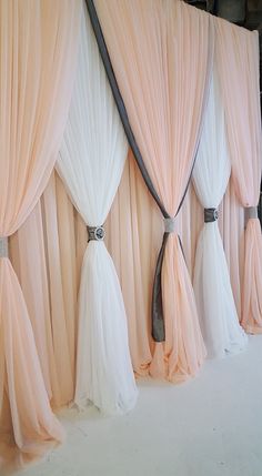 the curtains are lined up with tassels and ribbons on them, as if they were drapes