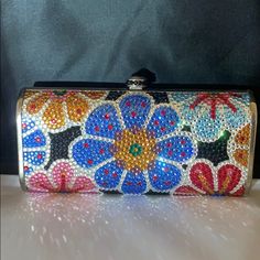 This Is A Brand New, Never Used, Evening Bag Fully Covered In Genuine Very Fine, Small Sized Swarovski Crystals From Austria! The Bag Is Covered In Both Sides With Spectacular Detail. It Is Also Lined In Genuine Leather. You Can Carry It As A Clutch But It Comes With A Long Detachable Metal Chain To Be Used As A Shoulder Strap So You Can Be Hands-Free! Handbag Comes With Extra Crystals. 5.75” Long * 2.75” H. Bag Is 3” Knob Included In Measurements 1.75” Wide Luxury Multicolor Handheld Clutch, Luxury Multicolor Pouch Evening Bag, Luxury Multicolor Pouch Clutch, Multicolor Clutch Shoulder Bag For Formal Occasions, Multicolor Clutch Bag For Formal Occasions, Luxury Multicolor Evening Bag As Gift, Formal Multicolor Clutch Shoulder Bag, Luxury Multicolor Rectangular Clutch, Designer Multicolor Shoulder Bag For Formal Occasions