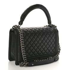 This is an authentic CHANEL Goatskin Quilted New Medium Boy Top Handle Flap in Black. This chic shoulder bag is crafted of diamond quilted goatskin leather in black, with aged silver chain links woven into the linear-quilted border. The bag features a sturdy rolled leather top handle with a matching woven detail, and an aged silver chain link shoulder strap with a leather shoulder pad. The crossover flap opens with a boy CC press lock to a black fabric interior with a patch pocket. Chanel Boy Bag Black, Chanel Print, Chanel Crossbody, Chanel Tweed, Quilted Wallet, Denim Quilt, Chanel Shoulder Bag, Chain Links, Diamond Quilt