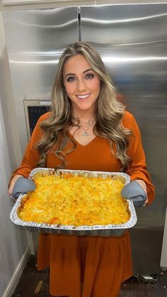 a woman holding a tray of food in her hands