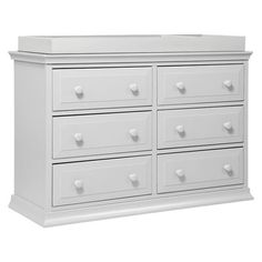 a white dresser with many drawers and knobs on it's sides, against a white background