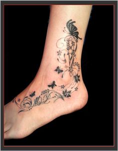 a woman's foot with flowers and butterflies on it