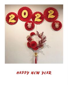 a happy new year card with red paper decorations