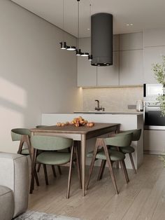 a modern kitchen and dining area with wood flooring, white walls and ceiling lighting