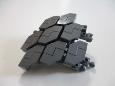 a bunch of black legos stacked on top of each other with holes in them