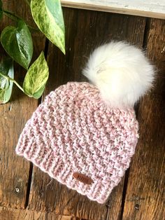 "This warm and cozy beanie hat is the perfect winter accessory! Ready to ship!  Chunky and soft with an adorable faux fur PomPom on top! So popular! The Pom is detachable with a wooden button inside.  I've added a sweet tag for that special \"Warrior\" in your life... is she you? The tag is positioned so that it can be worn in the middle or off to the side.  I've hand knit this beanie with an acrylic blend yarn that is so squishy and soft. I love it!  Size: fits a standard woman's head of 18-22\ Crochet Coffee Cozy, Cozy Beanie, Pompom Beanie, Pink Beanie, Winter Beanie Hat, Beginner Crochet Tutorial, Crochet Ear Warmer, Modern Knitting, Pink Beanies