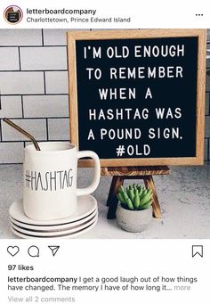 two coffee mugs sitting next to a sign that says i'm old enough to remember when a hashtag was a pound sign