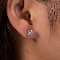 Elevate any outfit with the timeless elegance of Classic 1.0ct Moissanite Stud Earrings in White Gold by Evani Naomi Jewelry. Handcrafted from 92.5% pure silver and 7.5% hypoallergenic metals, these studs are dipped five times in 18k white gold to create a dazzling finish. The simple yet stunning six-prong design ensures the highest-quality sparkle, perfect for any occasion. With superior craftsmanship and affordable pricing, these earrings are a must-have addition to any fine jewelry collection Classic Hypoallergenic Diamond Earrings, Classic Hypoallergenic Diamond White Diamond Earrings, Hypoallergenic Classic Round Diamond Earrings, Classic Silver Moissanite Earrings, Hypoallergenic Diamond White Round Cut Earrings, Silver Solitaire Earrings With Lab Grown Diamonds, Simple Diamond Earrings, Diamond Carat Size, Cvd Diamond