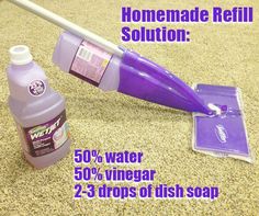 a purple mop and cleaning supplies sitting on the floor next to a bottle of cleaner