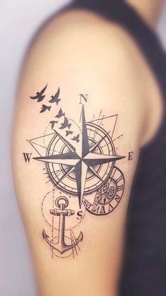 a man with a compass tattoo on his arm