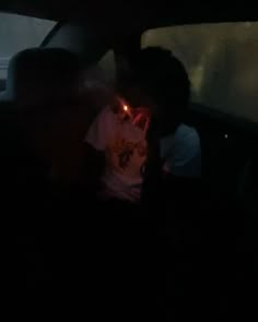 a person sitting in the back seat of a car with their headlight turned on