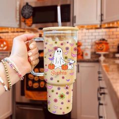 a person holding a cup with a ghost on it