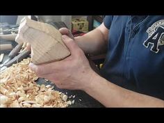 a man is working with wood shavings