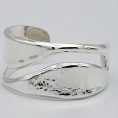 This unique and contemporary style has the best of both worlds: pounded and plain.  This cuff has a wavy split along its face, half the split is pounded and the other half is plain.   Wear this cuff on its own or stack it for a richer look.  This modern cuff is 32MM wide and its generous thickness is 3MM, and has a highly polished finish that is sure to shine from miles away. The Other Half, Other Half, Perfect Harmony, Contemporary Style