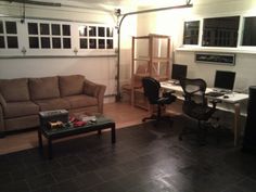 a living room filled with furniture and a computer desk