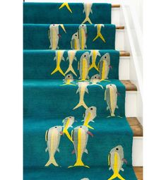 blue carpeted stairs with yellow and white fish on the bottom, along with matching rugs