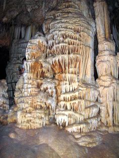 the inside of a cave filled with lots of stalate formations and icicles