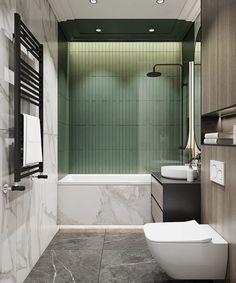 a modern bathroom with green tile walls and flooring, along with a white toilet