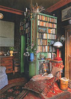 a living room filled with furniture and bookshelves covered in lots of bookcases