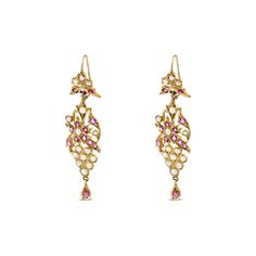 A lavishing set of dangle earrings featuring 24 round Ruby gemstones and 30 seed pearls. Dynamic floral designs beautifully crafted in 14 karat yellow gold. A Burdeen's Estate Top Pick, only one set available! Details: 14k Yellow Gold Dangle Earrings Gemstone Details: 24 Rubys Total Carat Weight: 2.16 carats Additional Gemstone Details: 30 Seed Pearls Size: 2-3 mm each All carat weight is estimated unless otherwise stated above. Yellow Gold Pearl Drop Temple Earrings, Yellow Gold Temple Jewelry Earrings With Pearl Drop, Elegant Yellow Gold Hallmarked Danglers, Elegant Hallmarked Yellow Gold Danglers, Formal Temple Jewelry Pearl Drop Earrings, Elegant Yellow Gold Danglers For Formal Occasions, Elegant Yellow Gold Formal Danglers, Elegant Formal Yellow Gold Danglers, Elegant Yellow Gold Danglers With Intricate Design